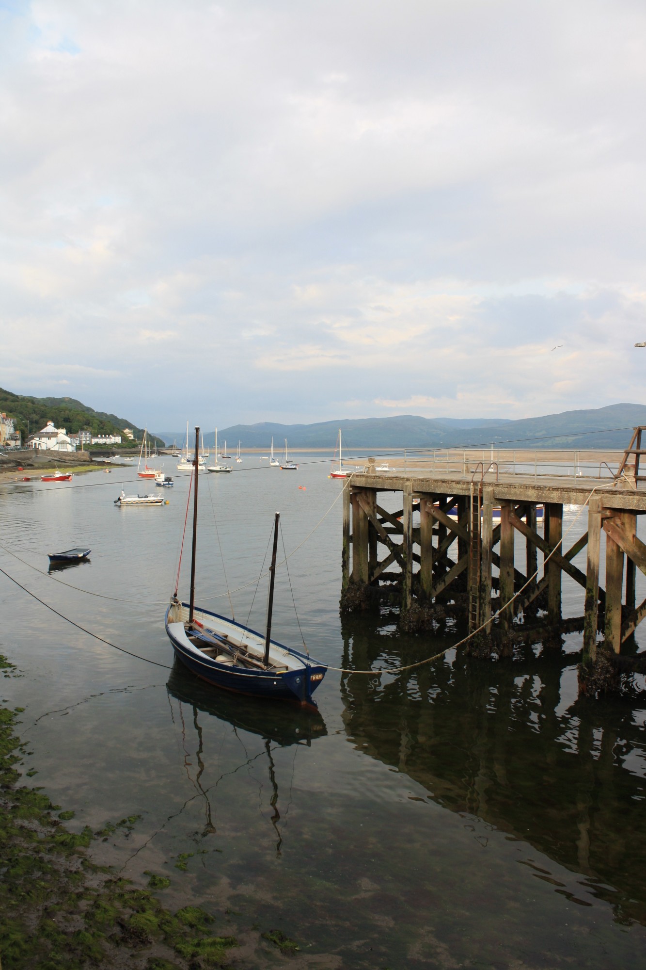 Looking down at a blue boat in Aberdovey pier