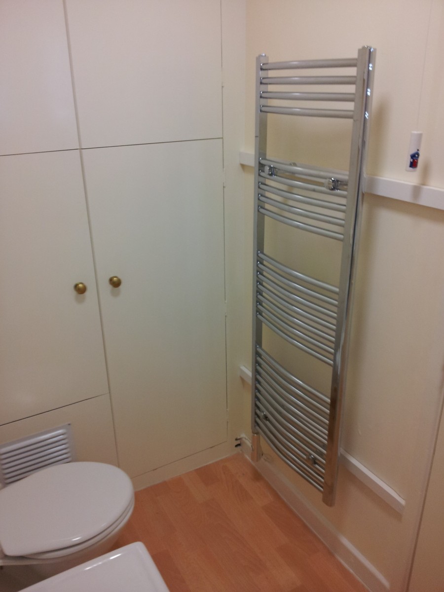 The bathroom has a bath, shower and towel rail for drying your towels.